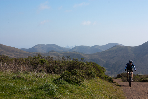 Cyclist on Coastal Fire Trail with San Francisco in the Background